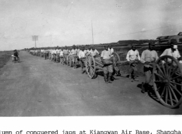 Column of conquered Japanese soldiers at Kiangwan Air Base, Shanghai.  Photo from Milton King.