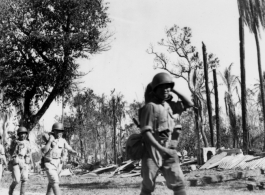 Chinese troops on the move in a wrecked area of Burma, during WWII.  Photo by C. W. Leipnitz.