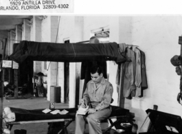 A GI writes at a bunk in Photo Recon Squadron barracks during WWII.  Photo from Robert Travis Keagle.