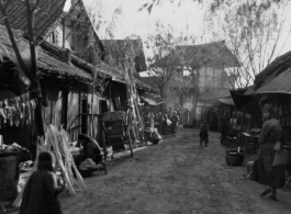 Market stall lining a small road in a Chinese village during WWII.  Photo from Malcolm J. Petzer.