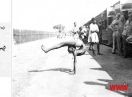A contortionist puts on a display for GIs at a rest stop on the train ride to Ranikhet Rest Camp.  In the CBI during WWII.