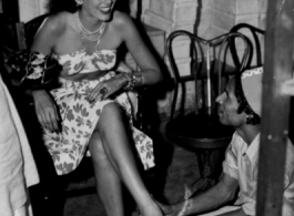 Jinx Falkenburg getting shoe fitted in Calcutta, India, in 1944 or 1945, USO troupe.