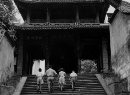 A well-off Chinese family climbs steps to a temple in the CBI during WWII.