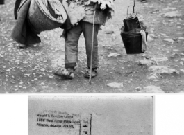 A Chinese man carries his possessions on a shoulder pole in the CBI during WWII.