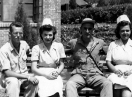 Nurses and GIs pose on a bench for the camera in the CBI during WWII.  Photo from Bruno F. Birsa.