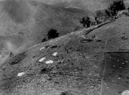 Allied airdrop on a hillside in SW China (or Burma), during WWII.  Image provided by Emery and Beth Vrana.