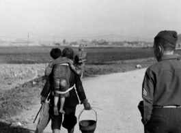 Chinese mother carries baby near Kunming, April 1945.