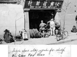 Chinese soldiers looking on at tire shop in Kunming, China, October 1945.