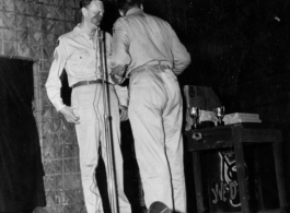 GIs prepare to perform during 54th Air Service Group entertainment, with instruments of the "Jive-o-Lieps" in the background. In the CBI during WWII.