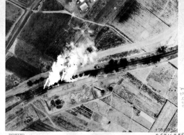 Steam billows from two Japanese locomotives whose boilers have been exploded by strafing of 2nd Lt. William C. Sharp, a member of CACW. Near Suchow (Suzhou), China, during WWII.