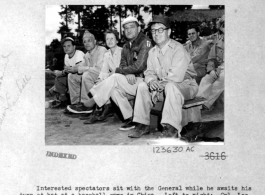 "Interested Spectators Sit With The General While He Awaits His Turn At Bat At A Baseball Game In China. Left To Right: Cpl. Lee Gordon, Colonel Zeondioff, Major Shevallier, Major General C.L. Chennault, And Don Barclay."