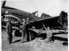 A P-40 under maintenance by American and Chinese crews in Kunming, China.
