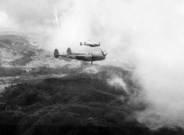 P-38s in flight in the CBI, in the area of southern China, Indochina, or Burma, during WWII.