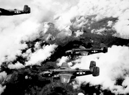 B-25 Mitchell bombers, including tails nos #264650 and #129900, in flight in the CBI, in the area of southern China, Indochina, or Burma.