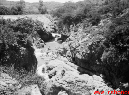 A dam and and falls about 8 miles southeast of the Luliang air base area in Yunnan province, China, where the GIs went to swim and relax. During WWII.