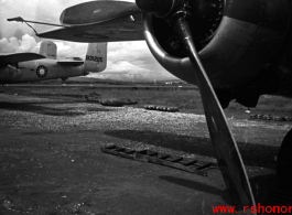 A B-25, tail number #B31205, with bombs laid out ready for loading, at the base. WWII in Yunnan province, China.