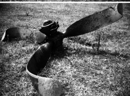 A crash at the American air base in WWII in Luliang, Yunnan province, China, showing the broken aircraft propeller and the gouge across the grass where the aircraft slid.