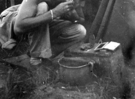 Frank G. Ehle shaving in a tent along the Burma Road during WWII.
