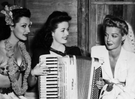 Celebrities visit and perform at Yangkai, Yunnan province, during WWII: Jinx Falkenburg, Ruth Dennis, and Ann Sheridan pose together.