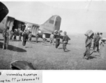 Local laborers unload supplies from an American C-47 in Mengsa or Szemao. In the CBI during WWII.