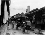 A pleasant market street in China, probably Kunming, during WWII.