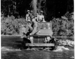 Several GIs cross river in jeep during WWII, in SW China or Burma.