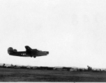 A B-24 in the air over a runway in the CBI during WWII.  Image provided by Emery and Beth Vrana.
