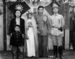 A wartime wedding in Yunnan province, China, with a very young and unenthusiastic bride.  See alternative image here.