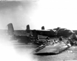 In the foreground of this revetment are the remains of a North American B-25 bomber, like the one in the background, after it burnt up. This was possibly due to a night attack by Japanese bombers.