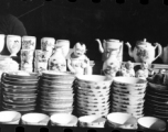 Decorative china cups, tea pots, and figurines in a china shop in China during WWII.