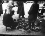 A street-side shoe vendor in China during WWII.  From the collection of Hal Geer.