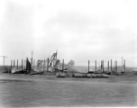 Burned building and fuel barrels at an American base, likely at Guilin, China.
