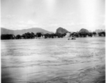 A river crossing, probably near Liuzhou (Liuchow) city, Guangxi province, China, during WWII.  Note the horse or mule riding the small boat.  Selig Seidler was a member of the 16th Combat Camera Unit in the CBI during WWII.