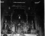 GIs and Chinese man inside a temple in China, probably at Confucian or Daoist temple. During WWII.