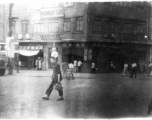 Street scene in China, with the Paramount Cafe in the background. During WWII.