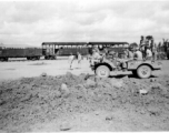 Kealy, Johnny Burns, Schmidt, Hammett, Alexander, Nash, Nyreen, Alelunas, Sam Knox, Liuzhou, September 1944. Train in the background is full of barrels of fuel. The disturbed ground in the foreground is likely caused by bombing.  From the collection of Frank Bates.