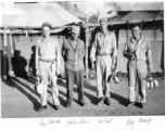 GIs pose with mess gear in front of tents in the CBI during WWII: Joey Barus, Archie Shiun, Joe Pruit, Ray Michell.