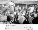 "Village scene in Mengsa or Szemao" in SW China, in 1944, during WWII. Likely market day activities.