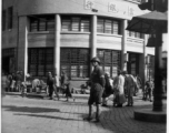 Scenes around Kunming city, Yunnan province, China, during WWII: Street corner with a stern traffic cop and the "Kunming Commercial Bank, Ltd."