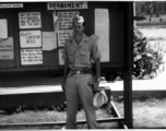 Henry Weiss of Brooklyn, NY; Tec 4, 219th Signal Depot Company, standing before a bulletin board at Tollygunge, India, during WWII.