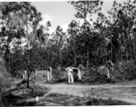 GI explorations of the hostel area at Yangkai air base during WWII: A GI looks at local graves.