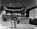 Photographer Eugene Wozniak and a language interpreter take a stroll about in Yunnan, China, during WWII.