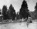 GIs do poolside R&R, during WWII, at hilltop rest house or manor house. In India? Ceylon? Note round crenelated tower in the background.