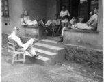 GIs resting at barracks area, likely at Yangkai, during WWII.  Smiley on right.