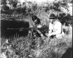 Capt. O. D. Propps, American Liaison Officer, and Col. Tung Tau, commanding 388 Regiment, 130th Division, 53rd Chinese Army, inspect captured Japanese heavy machine gun, captured on Li La Hill northwest of Chefang. This machine gun fires 7.92 mm ammunition.  Yunnan Province on November 28, 1944.   Photo by T/5 W. E. Shemorry. B-Detachment, 164th Signal Photographic Company, APO 627.  Passed by William E. Whitten.