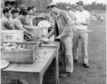 GIs line up for food distributed by Chinese staff, while enjoying AAF Day celebrations, August 1, 1945, at Yangkai, APO 212, during WWII.