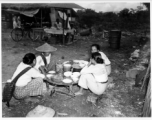 Local people in Burma near the 797th Engineer Forestry Company--Ladies chat over food and drink at a market in Burma.  During WWII.