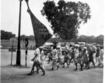 People with large banner marching in India, during WWII.