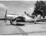 A Republic P-47B Thunderbolt, tail #227738, on pavement at an airbase in in Burma during WWII. P-38 #423800 is behind.