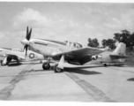 A P-51 fighter on pavement at an American air base in Burma during WWII.